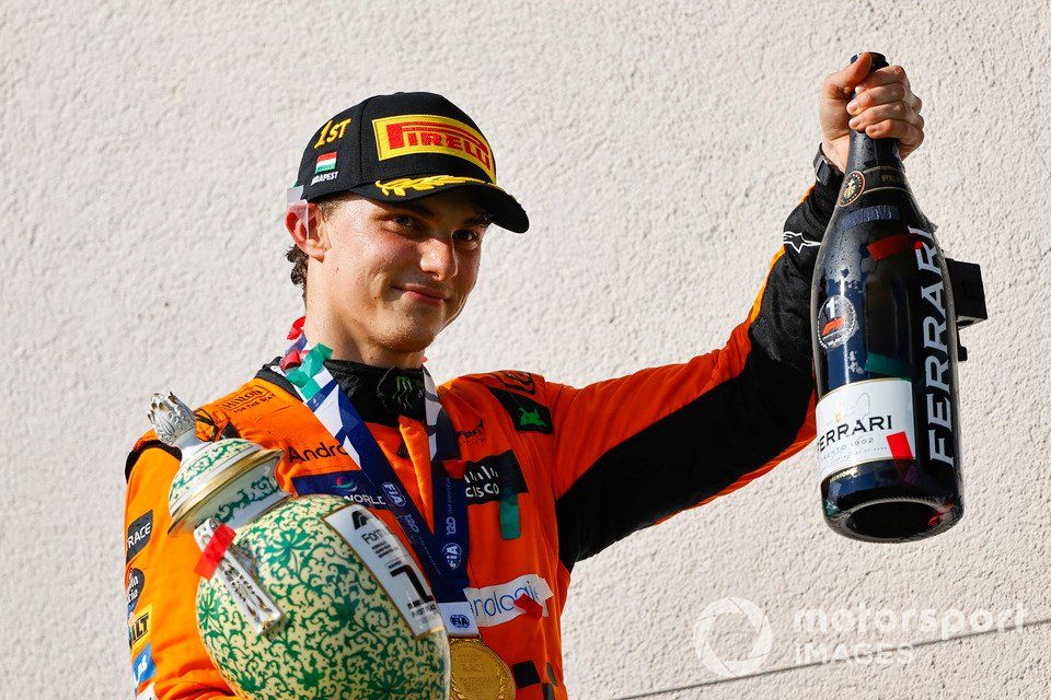 Oscar Piastri, McLaren F1 Team, 1st position, leaves the podium with his trophy and Champagne