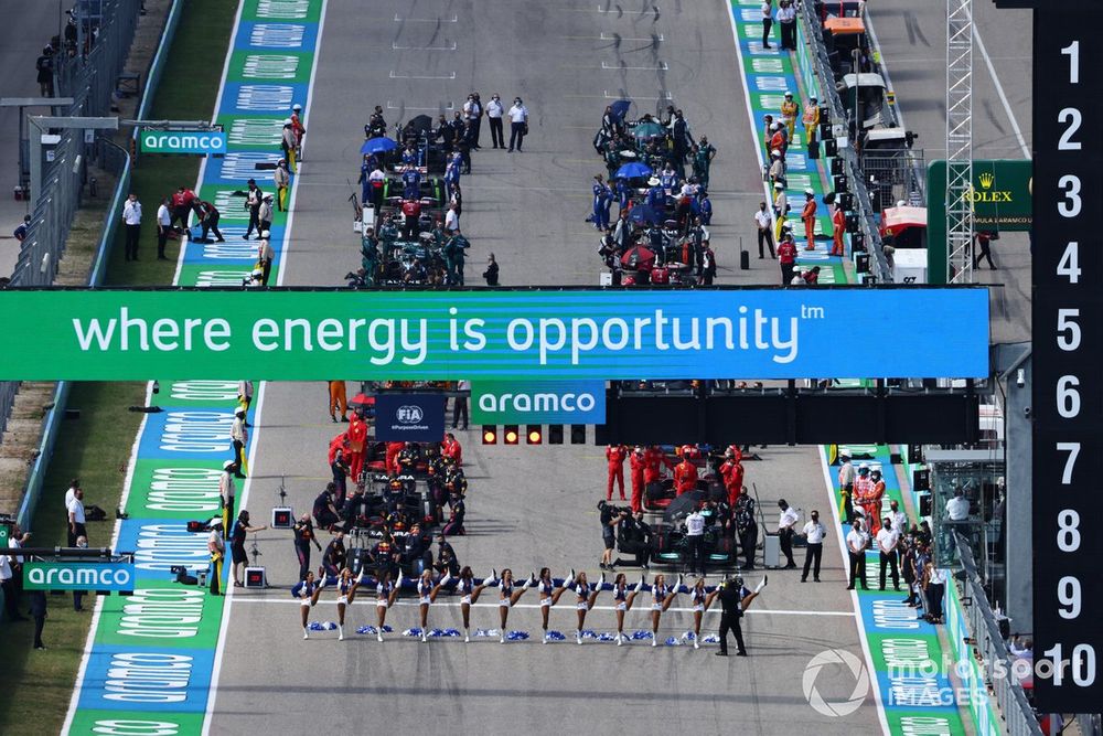 The Dallas Cowboys Cheerleaders perform at the front of the grid prior to the start