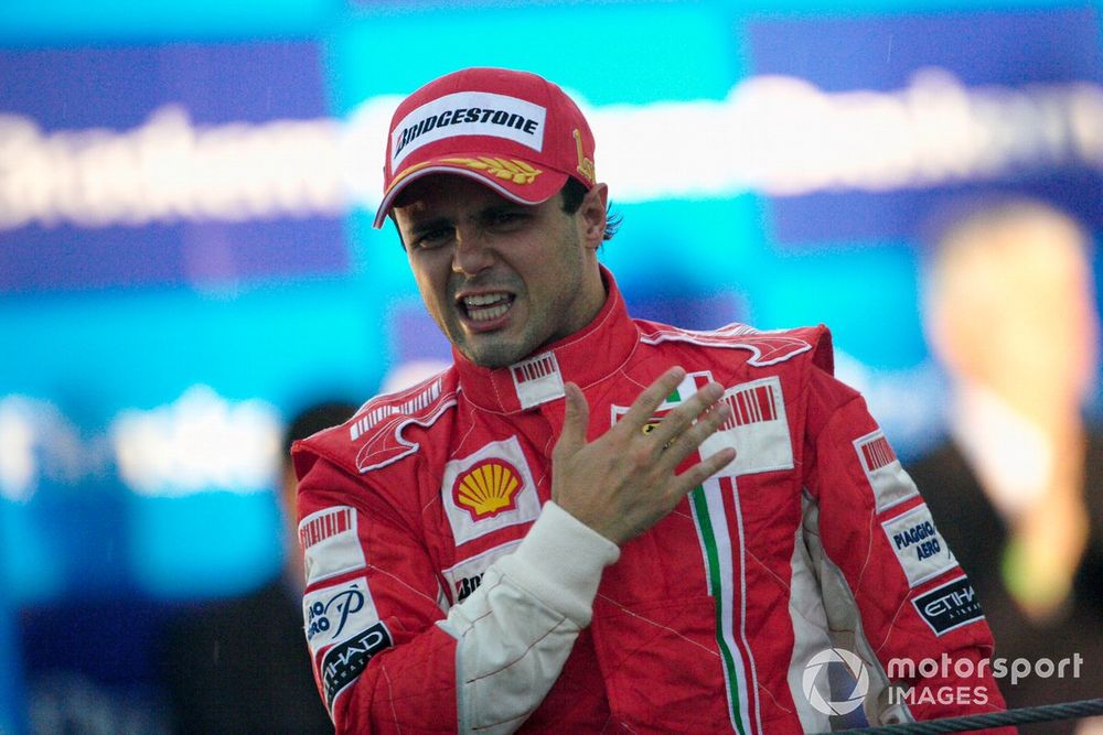 An emotional Felipe Massa proudly slaps the Prancing Horse insignia on his chest as he celebrates victory and a well fought season in front of his home fans