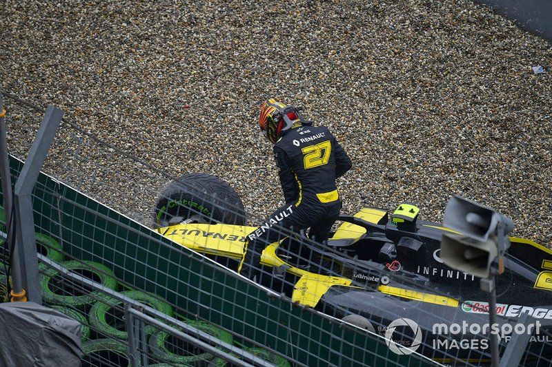 Nico Hulkenberg, Renault F1 Team, climbs out of his damaged car and retires from the race