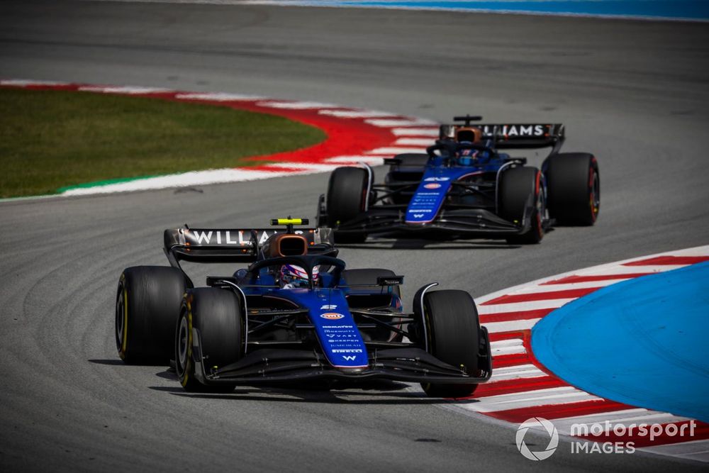 Logan Sargeant, Williams FW46, leads Alex Albon, Williams FW46