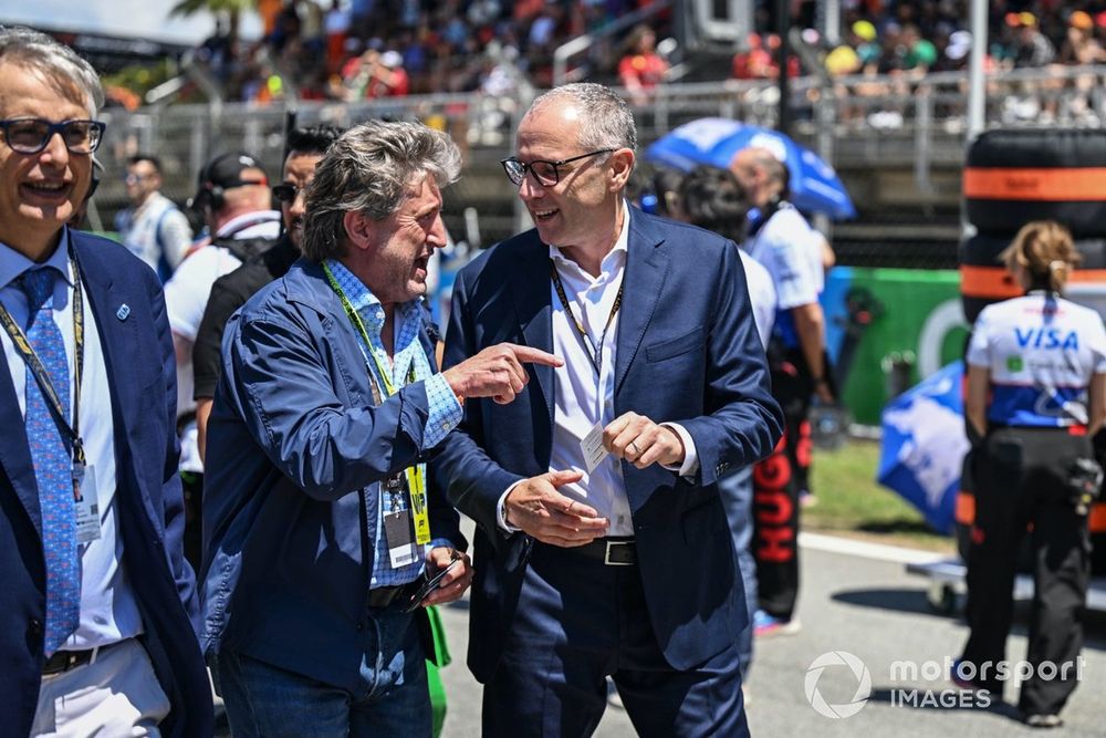 Stefano Domenicali, CEO, Formula One Group, on the grid with a guest