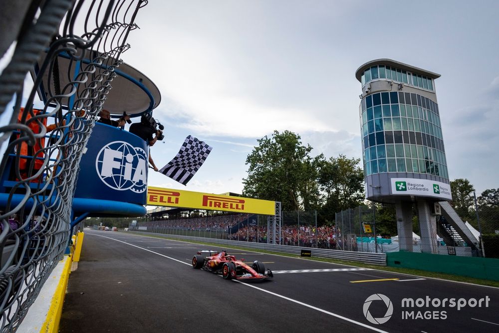 The chequered flag is waved as Charles Leclerc, Ferrari SF-24, 1st position, crosses the finish line