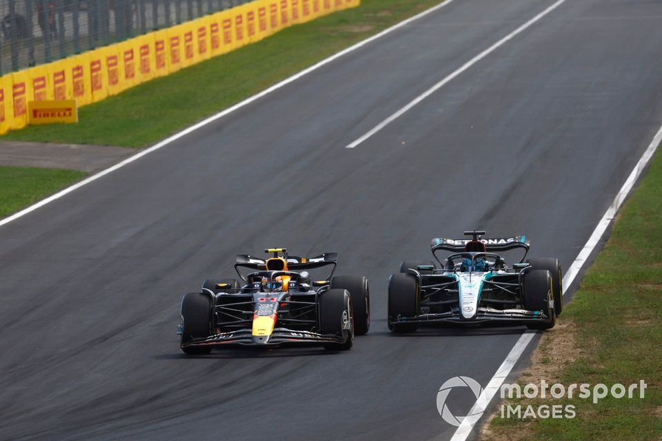 Sergio Perez, Red Bull Racing RB20, passes George Russell, Mercedes F1 W15