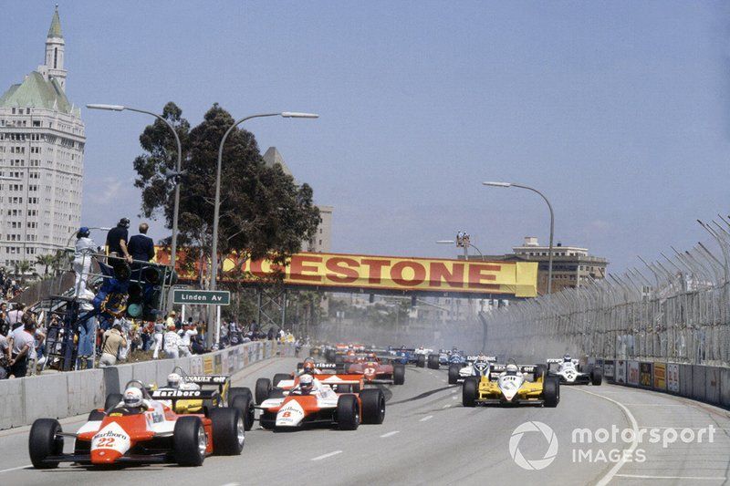 Andrea de Cesaris, Alfa Romeo 182 leads Niki Lauda, McLaren MP4/1B-Ford Cosworth, Rene Arnoux, Renault RE30B, Alain Prost, Renault RE30B,  Bruno Giacomelli, Alfa Romeo 182, Gilles Villeneuve, Ferrari 126C2, Nelson Piquet, Brabham BT49D-Ford Cosworth and Keke Rosberg, Williams FW07C-Ford Cosworth, at the start