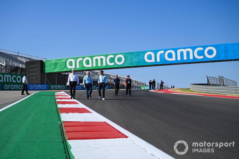 FIA officials walk the track, including steward Derek Warwick 