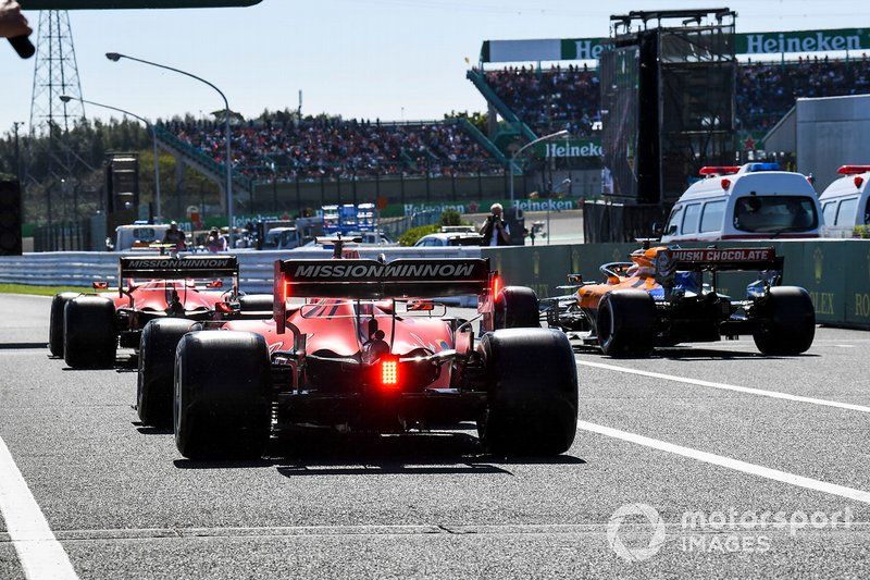 Charles Leclerc, Ferrari SF90, Carlos Sainz Jr., McLaren MCL34, and Sebastian Vettel, Ferrari SF90, in the pit lane at the start of Qualifying