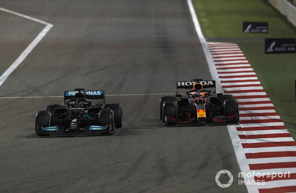 Lewis Hamilton, Mercedes W12, passes Max Verstappen, Red Bull Racing RB16B