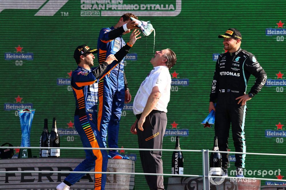 Daniel Ricciardo, McLaren, 1st position, Lando Norris, McLaren, 2nd position, and Zak Brown, CEO, McLaren Racing, celebrate on the podium with shoeys