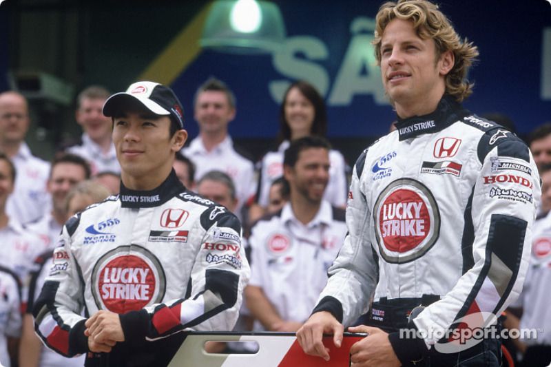 Jenson Button and Takuma Sato pose with BAR-Honda team members