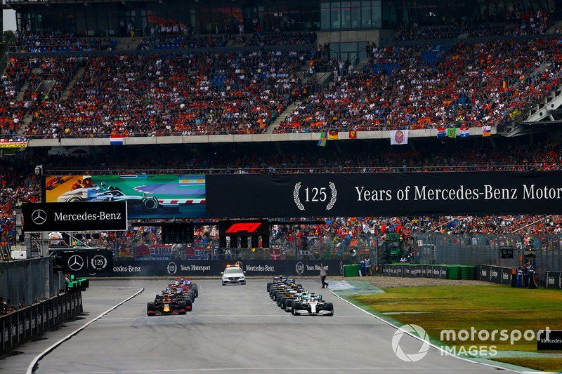 Lewis Hamilton, Mercedes AMG F1 W10, and Max Verstappen, Red Bull Racing RB15, prepare to lead the field away at the start