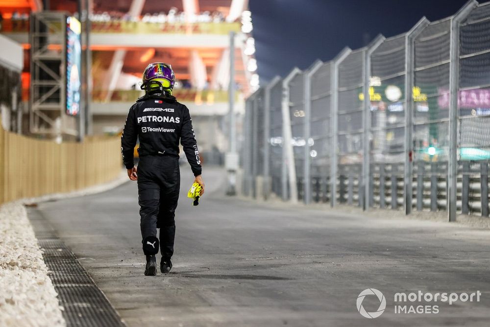 Lewis Hamilton, Mercedes-AMG, walks back after retiring from the race.